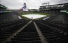 A tarpulin covers the diamond of Coors Field after a baseball game between the Miami Marlins and Colorado Rockies was postponed by stormy weather Tuesday, May 31, 2022, in Denver. The game will be made up as part of a doubleheader on Wednesday, June 1. (AP Photo/David Zalubowski)