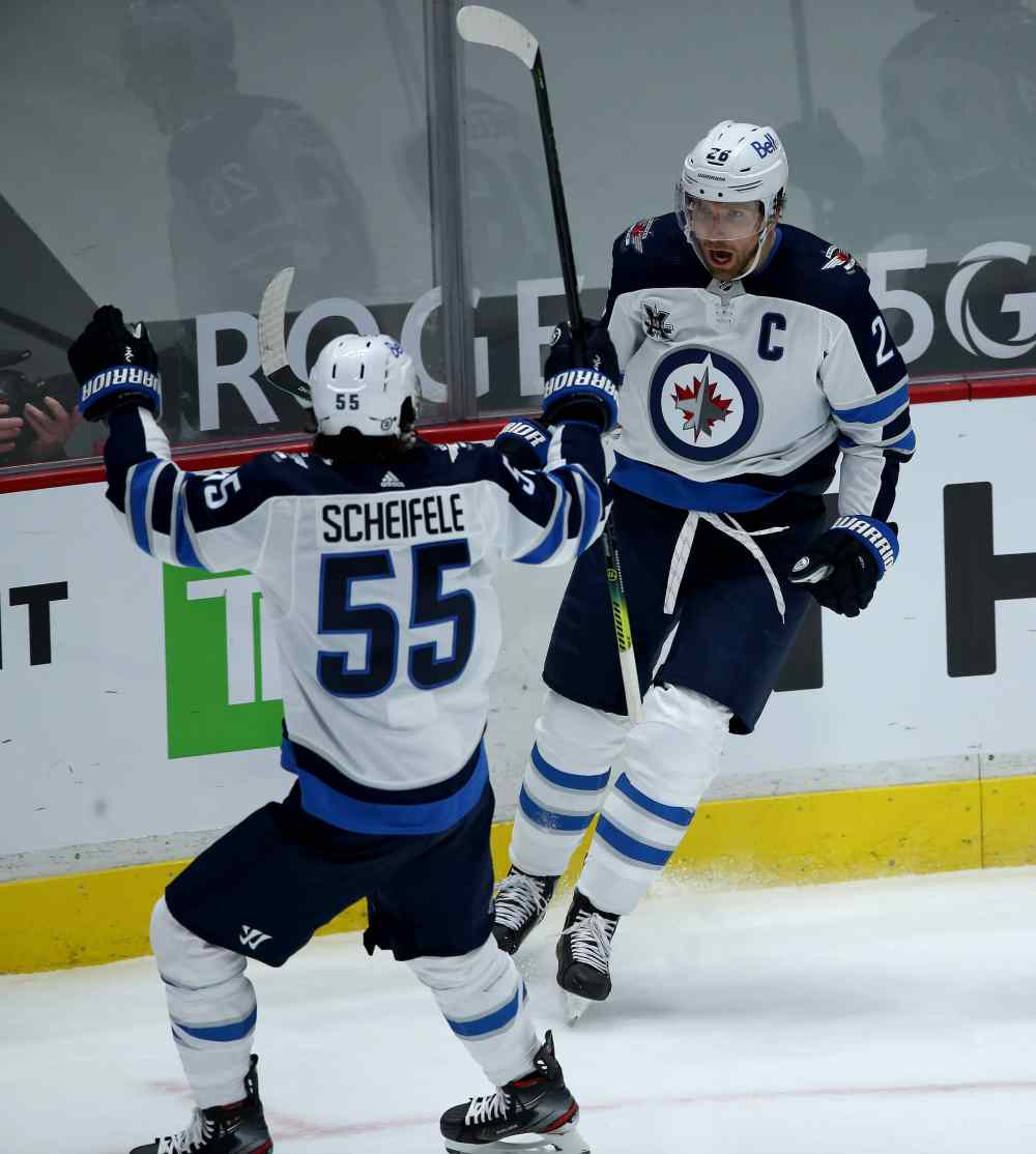 Winnipeg Jets' Mark Scheifele and Blake Wheeler celebrate after Blake Wheeler scored on Vancouver Canucks' goaltender Thatcher Demko during the first period. (TREVOR HAGAN / WINNIPEG FREE PRESS)