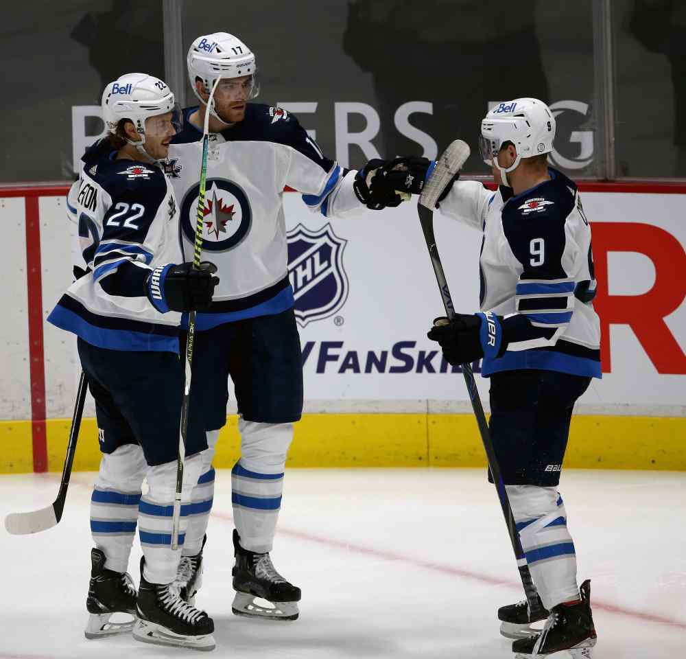 Winnipeg Jets' Mason Appleton, Adam Lowry and Andrew Copp celebrate after Adam Lowry scored his second goal of the game on the Vancouver Canucks. (TREVOR HAGAN / WINNIPEG FREE PRESS)