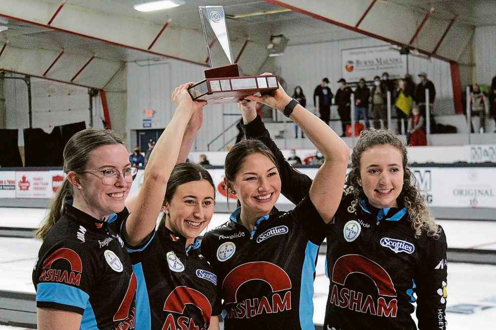 Brandon Sun Lead Lauren Lenentine, left, second Emily Zacharias, third Karlee Burgess and skip Mackenzie Zacharias hoist up the Manitoba Scotties Tournament of Hearts trophy after a 7-5 victory over Kristy Watling in Sunday's final at the Carberry Plains Community Centre. (Lucas Punkari/The Brandon Sun)
