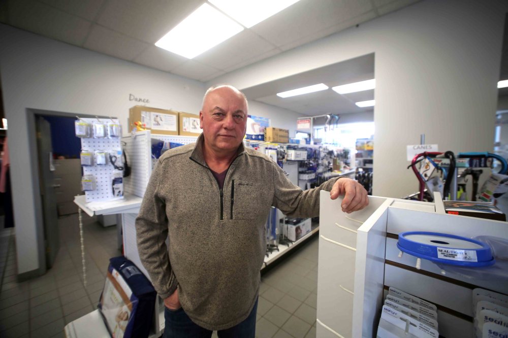 Les Wedderburn stands inside Rolling Spokes, which he co-owns. (Drew May/The Brandon Sun)