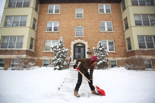MIKE DEAL / WINNIPEG FREE PRESS
Florance Smith shovels the front steps of the apartment building she manages on McMillan Avenue on Thursday morning. (Mike Deal / Winnipeg Free Press)

220414 - Thursday, April 14, 2022