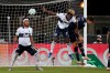 Sporting Kansas City midfielder Graham Smith (16) tries to head into the goal on a corner kick against Vancouver Whitecaps midfielder Leonard Owusu (17) and defender Derek Cornelius (13) defend during the first half of an MLS soccer match, Monday, July 27, 2020, in Kissimmee, Fla. (AP Photo/John Raoux)