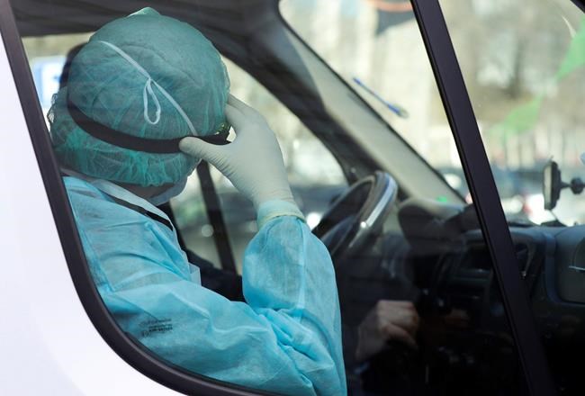 A medical employer in a protective suit sits inside an ambulance car near a hospital for infectious diseases in Minsk, Belarus, Friday, Feb. 28, 2020. Belarus, Lithuania and New Zealand have reported their first cases of coronavirus. The Public Health Agency of Canada says it will consult with the Canadian Federation of Nurses Unions on its next set of guidelines for health-care worker protection against the novel coronavirus, after the federation raised alarms about lax protocols — but the agency says there are concerns on the other side of the table as well. THE CANADIAN PRESS/AP/Sergei Grits
