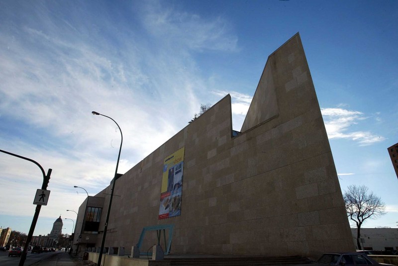 ken gigliotti  winnipeg free press  dec4 2002 feature on wpg architecture- Winnipeg Art Gallery WAG ,(old beater cars parked  at base  could not get better shot as building is underconstruction )-kg