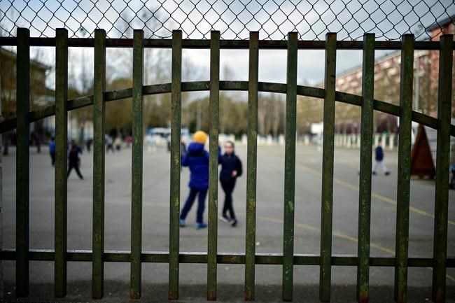Young students play in a public school, in Vitoria, northern Spain, Monday, March 9, 2020. Health authorities in the Madrid region say that infections for the new coronavirus have more than doubled in the past 24 hours. (AP Photo/Alvaro Barrientos)