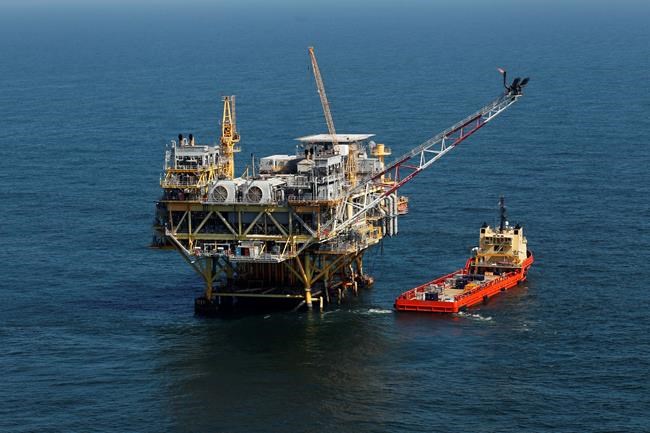 FILE - This Sunday, April 10, 2011 picture shows a rig and supply vessel in the Gulf of Mexico, off the cost of Louisiana. Thirteen states sued the Biden administration Wednesday, March 24, 2021 to end a suspension of new oil and gas leases on federal land and water and to reschedule canceled sales of offshore leases in the Gulf of Mexico, Alaska waters and western states. The Republican-leaning states, led by Louisiana Attorney General Jeff Landry, seek a court order ending the moratorium imposed after Democratic President Joe Biden signed executive orders on climate change on Jan. 27. (AP Photo/Gerald Herbert)