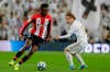 Athletic Bilbao's Inaki Williams, left, and Real Madrid's Luka Modric fight for the ball during a Spanish La Liga soccer match between Real Madrid and Athletic Bilbao at the Santiago Bernabeu stadium in Madrid, Spain, Sunday Dec. 22, 2019. (AP Photo/Paul White)