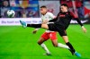 Augsburg's Ruben Vargas, right, and Leipzig's Tyler Adams fight for the ball during the German Bundesliga soccer match between Leipzig and Augsburg at the Red Bull Arena stadium in Leipzig, Germany, Saturday, Dec. 21, 2019. (AP Photo/Jens Meyer)