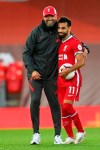 Liverpool's manager Jurgen Klopp, left, and Liverpool's Mohamed Salah celebrate at the end of the English Premier League soccer match between Liverpool and Leeds United, at the Anfield stadium, in Liverpool, Saturday, Sept. 12, 2020. (Shaun Botterill, Pool via AP)