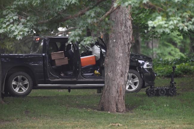 A police robot is shown near a pickup truck inside the grounds of Rideau Hall in Ottawa on Thursday, July 2, 2020. The RCMP say they have safely resolved an