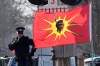 An Ontario Provincial Police officer talks on a radio after arrests were made at a rail blockade in Tyendinaga Mohawk Territory, near Belleville, Ont., on Monday Feb. 24, 2020, during a protest in solidarity with Wet'suwet'en Nation hereditary chiefs attempting to halt construction of a natural gas pipeline on their traditional territories. THE CANADIAN PRESS/Adrian Wyld