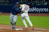 Houston Astros' Yuli Gurriel runs into Tampa Bay Rays first baseman Yandy Diaz after being thrown at first during the seventh inning in Game 3 of a baseball American League Championship Series, Tuesday, Oct. 13, 2020, in San Diego. (AP Photo/Gregory Bull)