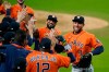 Houston Astros George Springer (4) and Jose Altuve celebrates with his teammates after winning Game 6 of a baseball American League Championship Series against the Houston Astros, Friday, Oct. 16, 2020, in San Diego. The Astros defeated the Rays 7-4 to tie the series 3-3. (AP Photo/Gregory Bull)