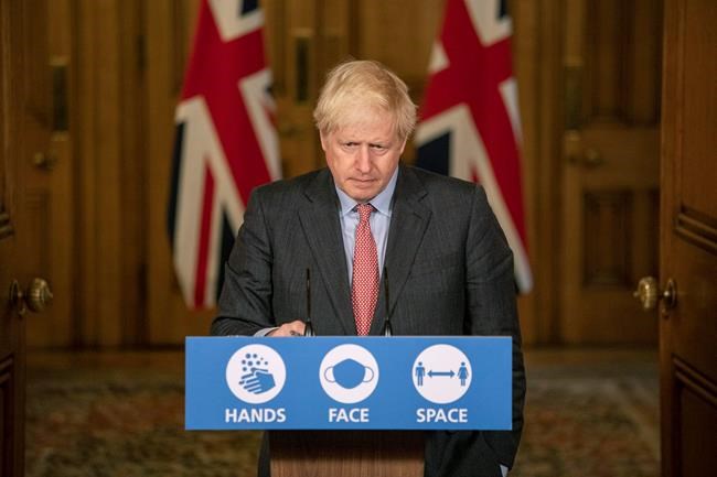 Britain's Prime Minister Boris Johnson listens, during a coronavirus briefing in Downing Street, London, Wednesday, Sept. 30, 2020. The number of new hospitalizations for COVID-19 and virus deaths in Britain are rising again, although both remain far below their springtime peak. (Jack Hill/Pool Photo via AP)
