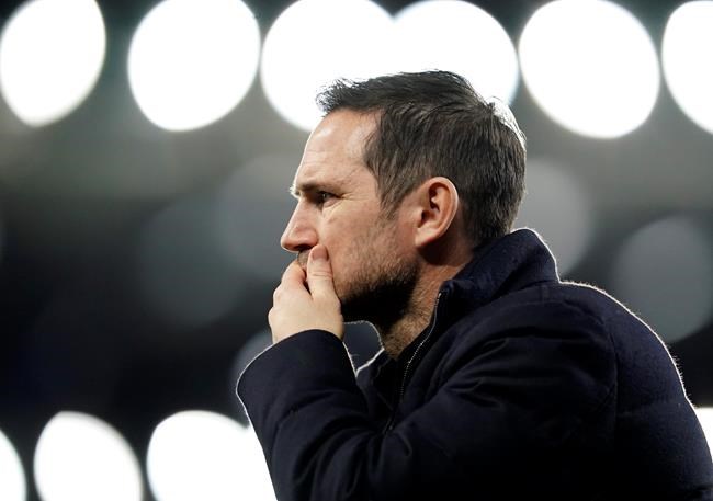 FILE - In this Saturday, Dec. 12, 2020 file photo, Chelsea's head coach Frank Lampard walks during the warm up before the English Premier League soccer match between Everton and Chelsea at Goodison Park in Liverpool, England. Lampard has been fired by Chelsea halfway through his second season in charge of the London club on Monday, Jan. 25, 2021 after being unable to replicate his success as the club’s record scorer in his first Premier League managerial job. Chelsea has lost five of its last eight Premier League games and dropped to ninth place, despite Lampard benefiting from nearly $300 million on new players for this season. (AP Photo/Jon Super, Pool, File)