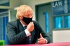 Britain's Prime Minister Boris Johnson meets Sixth form students during a visit to Accrington Academy in Accrington, England, Thursday, Feb. 25, 2021 as they prepare for the return of all pupils on March 8, (Anthony Devlin/Pool Photo via AP)
