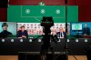 In this photo provided by DFB, from left, Germany soccer coach Joachim Low appearing via video link, German soccer federation spokesman Jens Gritter, President of the DFB Fritz Keller and team manager Oliver Bierhoff take part in an online press conference without any journalists because of fears over the new coronavirus, Wednesday, March 18, 2020. Low thinks the coronavirus pandemic is a sign that Earth is “defending itself a bit” against modern society, and said the widespread outbreak should be a wake-up call for people focused only on ”power, greed, profit.