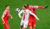 Cologne's Sebastian Andersson, centre, and Mainz's Stefan Bell fight for the ball, during the German Bundesliga soccer match between Cologne and Mainz, at Rhein-Energie-Stadion, in Cologne, Germany, Sunday, April 11, 2021. (Federico Gambarini/dpa via AP)