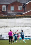 A spectator watches the game from behind a fence, during the English FA Cup third round match between Chorley and Derby County, at Victory Park in Chorley, England, Saturday Jan. 9, 2021. (Martin Rickett/PA via AP)