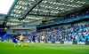 Brighton soccer fans adhere to social distancing measures in the stands as they watch the action on the pitch during the pre-season friendly between Brighton and Chelsea, at the AMEX Stadium in Brighton, England, Saturday, Aug. 29, 2020. Up to 2500 fans have been allowed in to watch the match after the government announced a further batch of sporting events that will be used to pilot the safe return of spectators. (Adam Davy/PA via AP)