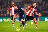 Tottenham Hotspur's Harry Kane, left and Southampton's Jan Bednarek battle for the ball, during the English Premier League soccer match between Southampton and Tottenham Hotspur at St Mary's Stadium, in Southampton, England, Wednesday Jan. 1, 2020. (Mark Kerton/PA via AP)
