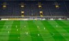 FILE - In this Feb. 18, 2017 file photo, players challenge for the ball in front of the empty south tribune because of a ban following fan trouble during the German Bundesliga soccer match between Borussia Dortmund and VfL Wolfsburg at Germany's biggest stadium in Dortmund, Germany. Bundesliga will now restart on May 16, 2020 when Dortmund will play the derby against Schalke at home without spectators due to the coronavirus outbreak. (AP Photo/Martin Meissner, file)