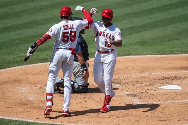 Los Angeles Angels' Justin Upton, right, celebrates his solo home run with Jo Adell in the second inning of a baseball game against the Seattle Mariners in Anaheim, Calif., Monday, Aug. 31, 2020. (AP Photo/Kyusung Gong)