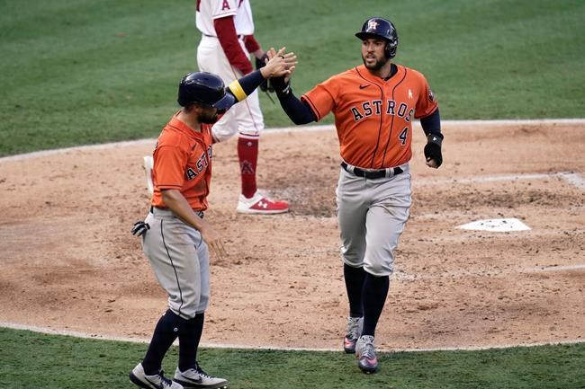 Houston Astros' George Springer, right, and Jack Mayfield high-five after they scored on a single hit by Yuli Gurriel during the third inning of the first baseball game of a doubleheader against the Los Angeles Angels, Saturday, Sept. 5, 2020, in Anaheim, Calif. (AP Photo/Jae C. Hong)