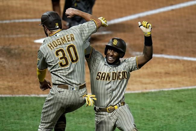 San Diego Padres' Jurickson Profar, right, celebrates his two-run home run with Eric Hosmer during the fourth inning of a baseball game against the Los Angeles Angels, Wednesday, Sept. 2, 2020, in Anaheim, Calif. (AP Photo/Jae C. Hong)
