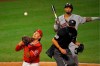 Los Angeles Angels catcher Jason Castro, left, catches a ball that was fouled off the ground by Houston Astros' Martin Maldonado, upper right, as home plate umpire Cory Blaser watches during the ninth inning of a baseball game Friday, July 31, 2020, in Anaheim, Calif. Houston Astros' Myles Straw advanced to second on the play. (AP Photo/Mark J. Terrill)