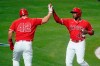Los Angeles Angels' Justin Upton, right, is high-fived by Mike Trout after they both scored on single from Jared Walsh during the fourth inning of a baseball game against the Minnesota Twins Friday, April 16, 2021, in Anaheim, Calif. (AP Photo/Marcio Jose Sanchez)