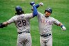 Texas Rangers' Nate Lowe, right, celebrates his home run with Jonah Heim during the eighth inning of a baseball game against the Los Angeles Angels, Wednesday, April 21, 2021, in Anaheim, Calif. (AP Photo/Jae C. Hong)