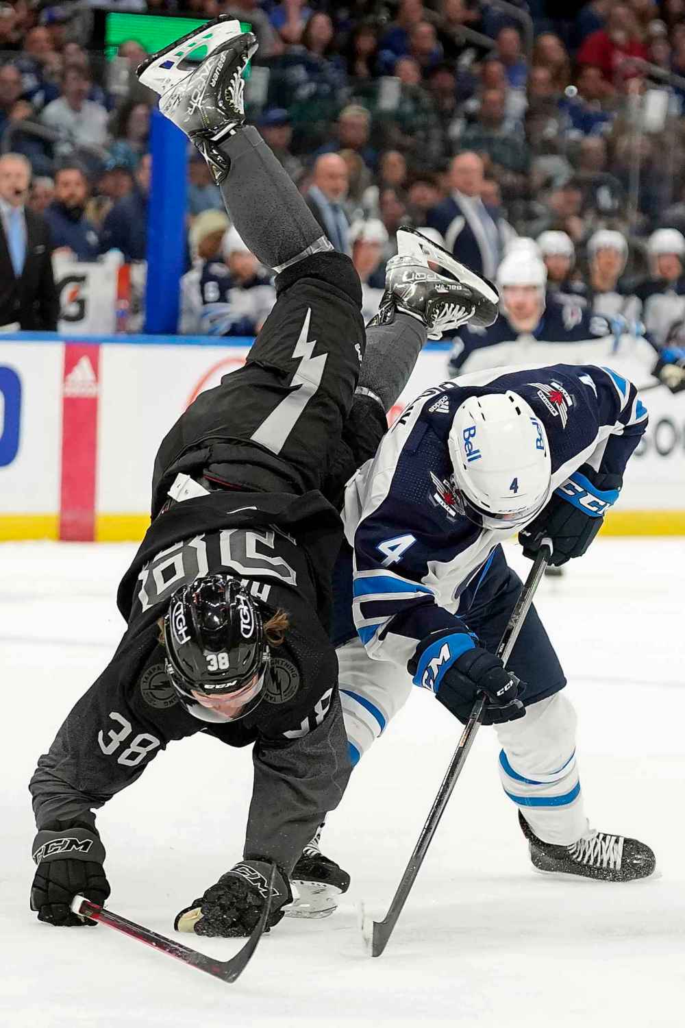 CP
Winnipeg Jets defenseman Neal Pionk upends Tampa Bay Lightning left wing Brandon Hagel during the second period. (Chris O'Meara / The Associated Press)