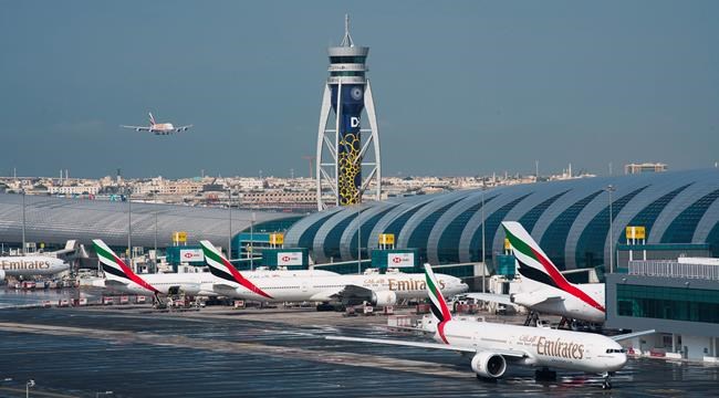 FILE - In this Dec. 11, 2019, file photo, an Emirates jetliner comes in for landing at Dubai International Airport in Dubai, United Arab Emirates. Dubai International Airport, the world's busiest for international travel, said Thursday, Jan. 23, 2020, that it is taking special precautions to screen the droves of Chinese tourists expected for the Lunar New Year holiday after the outbreak of a pneumonia-like virus that has led to China's lockdown of the entire city of Wuhan. (AP Photo/Jon Gambrell, File)