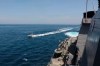 In this Wednesday, April 15, 2020, photo made available by U.S. Navy, Iranian Revolutionary Guard vessels sail close to U.S. military ships in the Persian Gulf near Kuwait. A group of 11 Iranian naval vessels made 