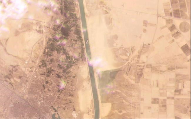 This satellite image from Planet Labs Inc. shows the cargo ship MV Ever Given stuck in the Suez Canal near Suez, Egypt, Tuesday, March 23, 2021. A cargo container ship that's among the largest in the world has turned sideways and blocked all traffic in Egypt's Suez Canal, officials said Wednesday, March 24, 2021, threatening to disrupt a global shipping system already strained by the coronavirus pandemic. (Planet Labs Inc. via AP)