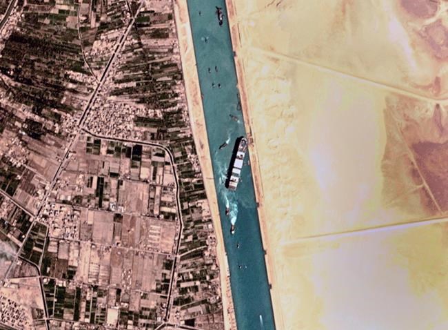 This satellite photo from Planet Labs Inc. shows the Ever Given cargo ship stuck in Egypt's Suez Canal Monday, March 29, 2021. Engineers on Monday