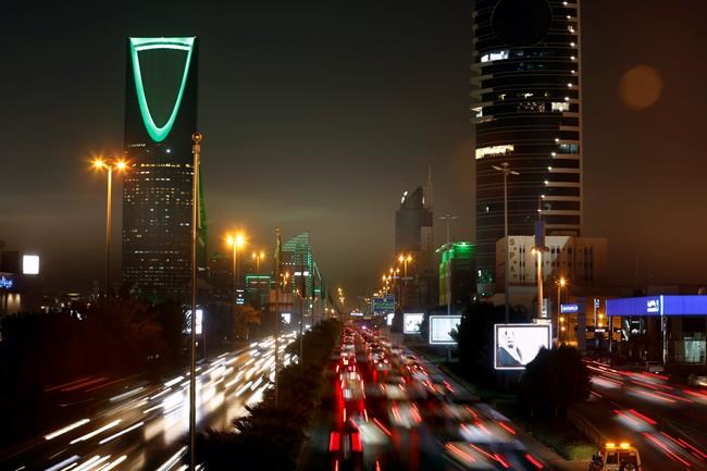 FILE- In this Sept. 22, 2019 file photo taken with a slow shutter speed, vehicles pass in front of the landmark Kingdom Tower, at left, during celebrations marking Saudi 89th National Day, in Riyadh, Saudi Arabia. The United States’ Gulf allies have pushed for hawkish policies by Washington to pressure, isolate and cripple Iran, but this high-stakes strategy is now being put to the test by the surprise U.S. killing of Iran’s most powerful military commander. As the region braces for what comes next, Saudi Arabia and the UAE are calling for de-escalation. (AP Photo/Amr Nabil, File)