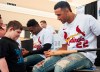 St. Louis Cardinals pitcher Jack Flaherty, right, talks with Brant Ballard, 15, before signing his baseball bat during the annual Cardinals Caravan event on Saturday, Jan. 18, 2020, in Jonesboro, Ark. (Quentin Winstine/The Jonesboro Sun via AP)