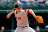 Boston Red Sox starting pitcher Garrett Richards works against the Texas Rangers during the first inning of a baseball game Sunday, May 2, 2021, in Arlington, Texas. (AP Photo/Jeffrey McWhorter)