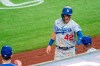 Los Angeles Dodgers' Matt Beaty in congratulated after scoring on a double by A.J. Pollock during the second inning of a baseball game against the Texas Rangers, Saturday, Aug. 29, 2020, in Arlington, Texas. (AP Photo/Jeffrey McWhorter)