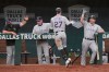Colorado Rockies' Trevor Story (27) is congratulated at the dugout after his home run in the fourth inning of a baseball game against the Texas Rangers, Sunday, July 26, 2020, in Arlington, Texas. (AP Photo/Louis DeLuca)