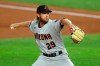 Arizona Diamondbacks starting pitcher Merrill Kelly (29) delivers against the Texas Rangers in the first inning of a baseball game Tuesday, July 28, 2020 in Arlington, Texas. (AP Photo/Richard W. Rodriguez)