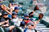 Milwaukee Brewers fans try to get a players attention from behind protective plexi-glass during a preseason baseball game against the Texas Rangers, Tuesday, March 30, 2021, in Arlington, Texas. (AP Photo/Michael Ainsworth)