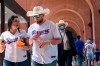 Josh Johnson and Zoe Aguilar walk through the concourse of Globe Life Field before the Texas Rangers home opener baseball game against the Toronto Blue Jays Monday, April 5, 2021, in Arlington, Texas. The Texas Rangers are set to have the closest thing to a full stadium in pro sports since the coronavirus shut down more than a year ago. (AP Photo/Jeffrey McWhorter)