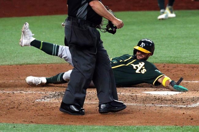 Oakland Athletics Vimael Machin scores in the third inning of a baseball game against the Texas Rangers Saturday, Sept. 12, 2020 in Arlington, Texas. (AP Photo/Richard W. Rodriguez)