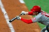 Los Angeles Angels starting pitcher Shohei Ohtani bunts his way on base against the Texas Rangers in the sixth inning during a baseball game on Monday, April 26, 2021, in Arlington, Texas. (AP Photo/Richard W. Rodriguez)