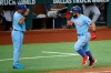 Texas Rangers' Rougned Odor, right, salutes with third base coach Tony Beasley, left, after hitting his second home run of the day in the fifth inning of a baseball game against the Houston Astros in Arlington, Texas, Sunday, Sept. 27, 2020. (AP Photo/Roger Steinman)