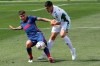 Atletico Madrid's Angel Correa, left vies for the ball against Elche's Diego Gonzalez during the Spanish La Liga soccer match between Valencia and Atletico Madrid at the Mestalla stadium in Valencia, Spain, Saturday, May 1, 2021. (AP Photo/Alberto Saiz)